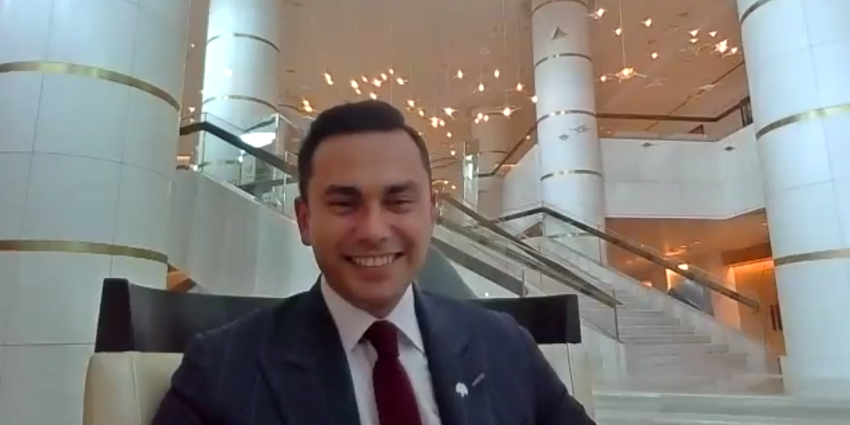 Cem Aksahin, Director of Food and Beverage at Raffles Hotel (Istanbul) smiling at the camera.